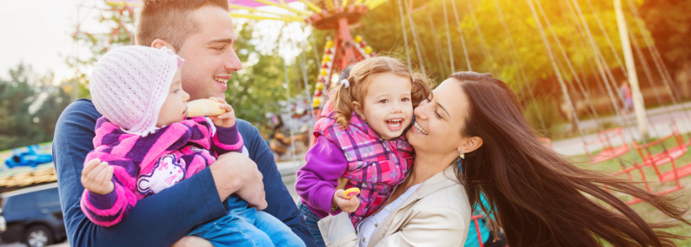 A family enjoying time at an amusement park. 