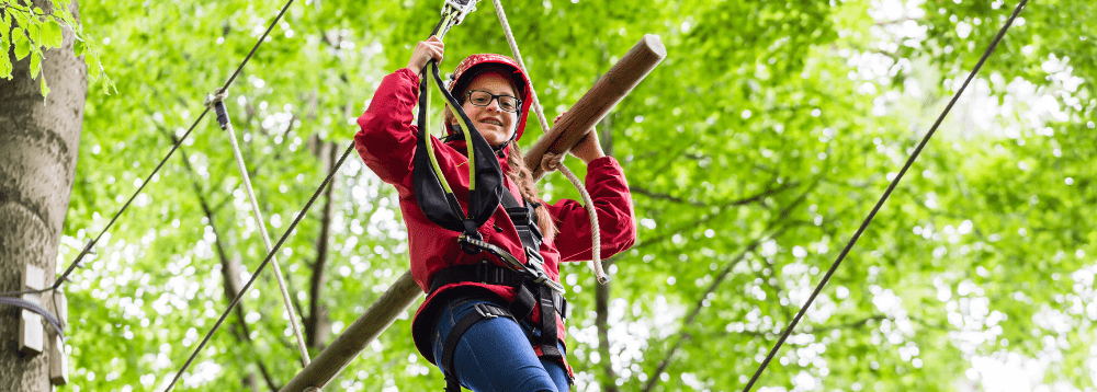 A picture of a child on a high ropes course.